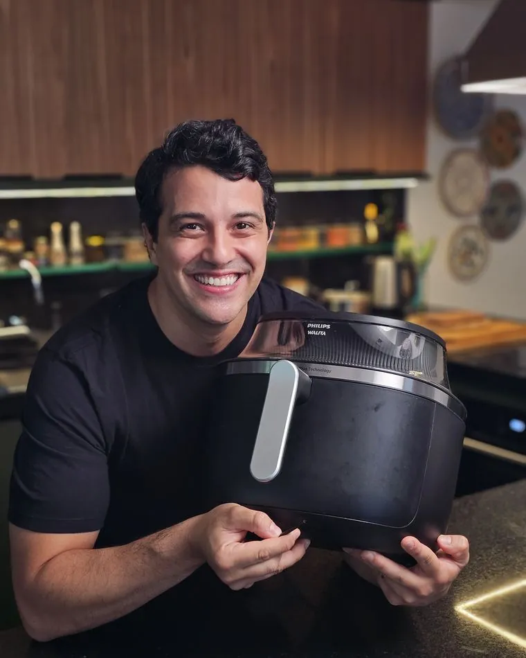 Gabriel Frazão segurando uma air fryer